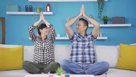 Married-couple-meditating-at-home.